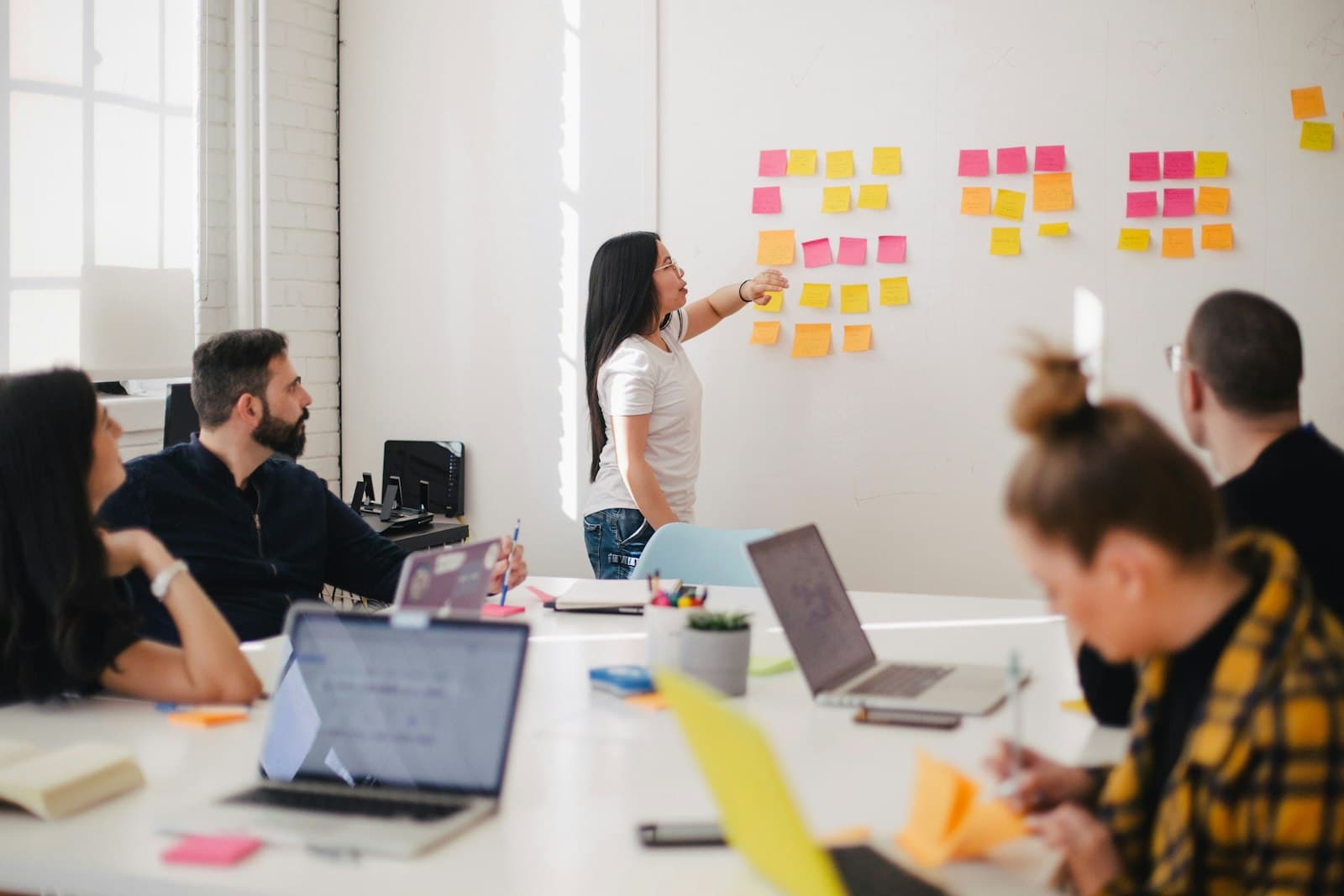 Project team planning a healthcare IT rollout with sticky notes on a whiteboard